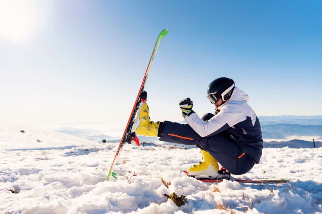 Ski equipment practicing balance exercise on a snowy mountain.